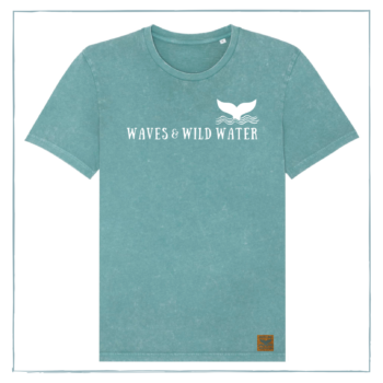 A green t-shirt with Waves & Wild Water printed across the front in white ink. There is also a logo with a whale tail coming out of waves on the chest.