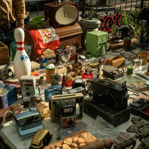 Assortment of Vintage and Antique Items Displayed on a Flea Market Stall