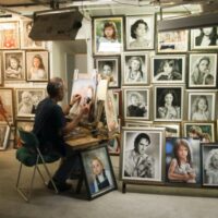 Man Sitting on Chair Painting Inside Room