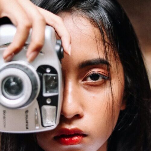 Photo Of Woman Holding Silver Camera