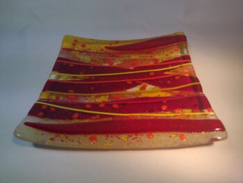 Red and yellow fused glass plate