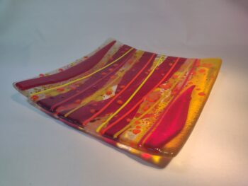 Red and yellow fused glass plate