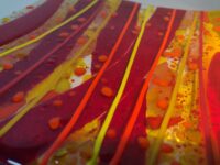 Red and yellow fused glass plate