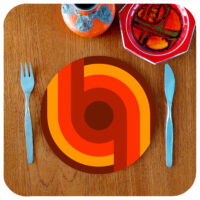 70s style round placemat on a teak table
